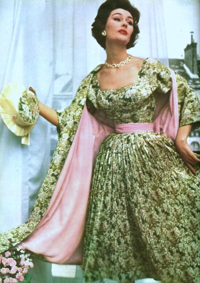 Anne Gunning in finely pleated floral print dress with matching coat lined in pink satin by Christian Dior, Paris Vogue, 1953