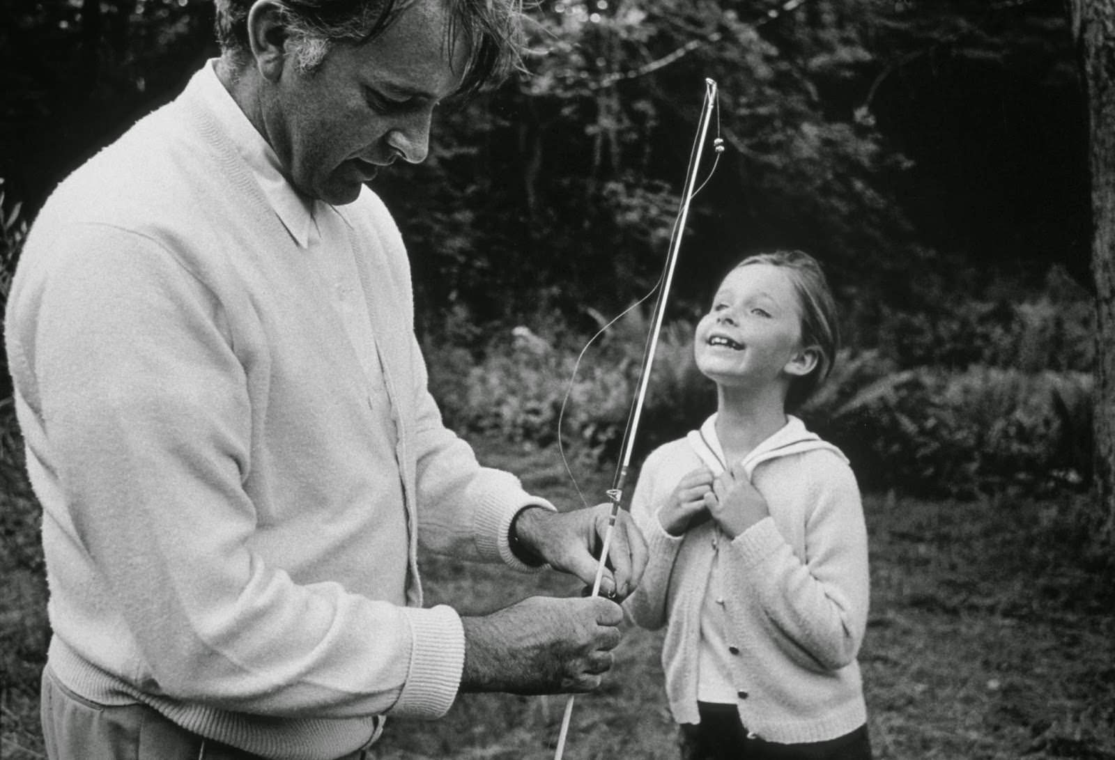 Richard Burton teaches his daughter Kate to fish on location in Northampton, Massachusetts, during filming of "Who's Afraid of Virginia Woolf?", 1965