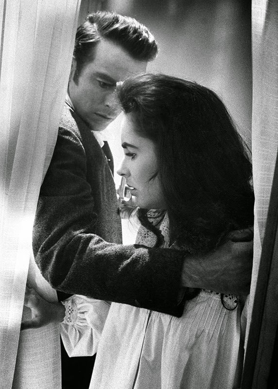 Montgomery Clift leads Elizabeth Taylor back to bed on the MGM set of "Raintree County," 1956