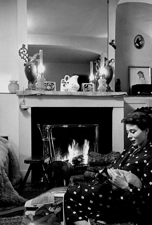 Bettina in her Paris apartment with her two Siamese cats, 1952