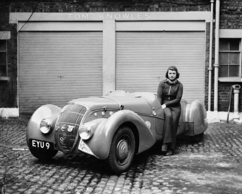 Miss Patten, Baroness Dorndorf sits on the door of her Peugeot, May 1939.