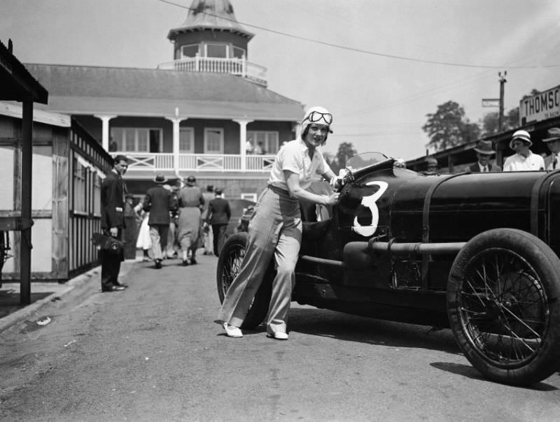 Miss Paddy Naismith pushing her car onto the track for one of the events at Brooklands, June 1933.