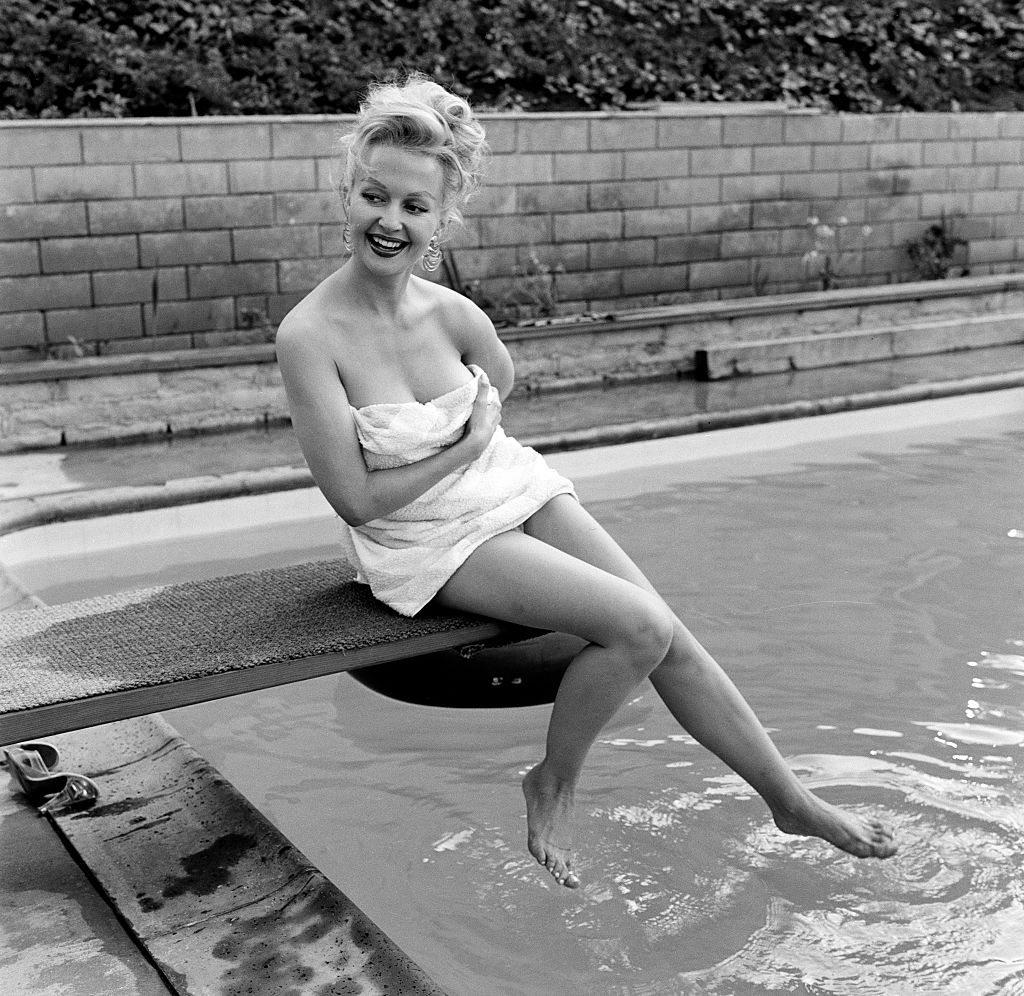 Greta Thyssen posing near the swimming pool, 1956.