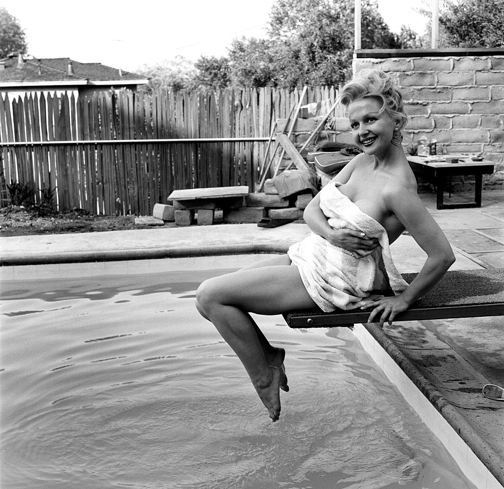 Greta Thyssen posing near the swimming pool, 1956.