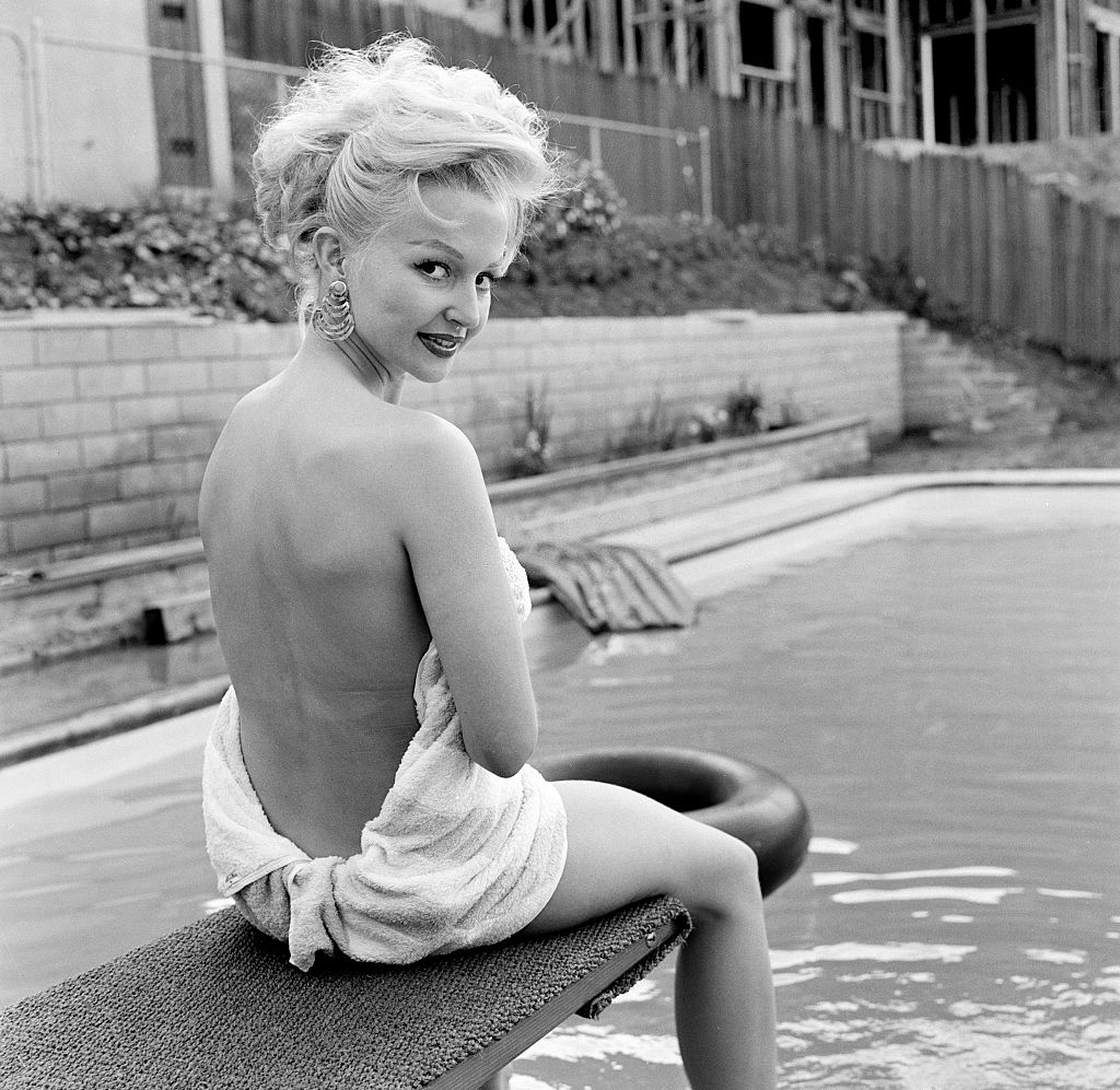 Greta Thyssen posing near the swimming pool, 1956.