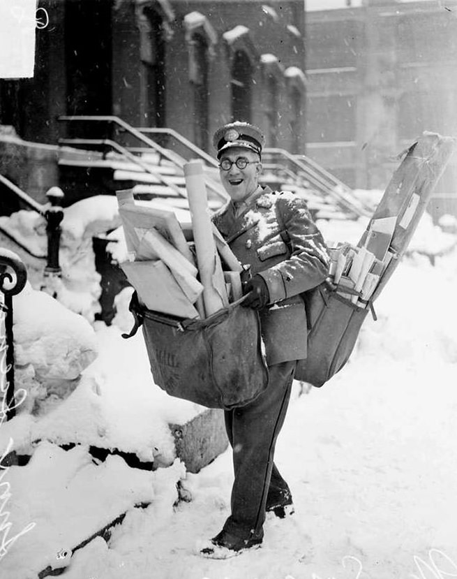 Mailman poses with his heavy load of christmas mail and parcels, chicago, 1929