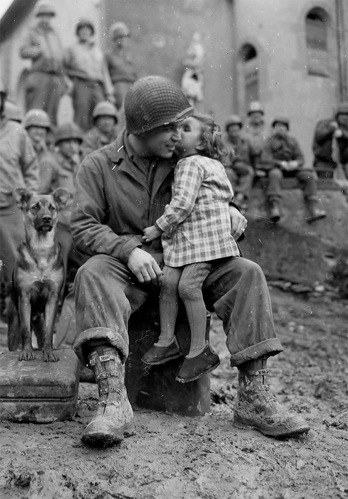 A little french girl gives an american soldier a kiss on valentine’s day, 1945