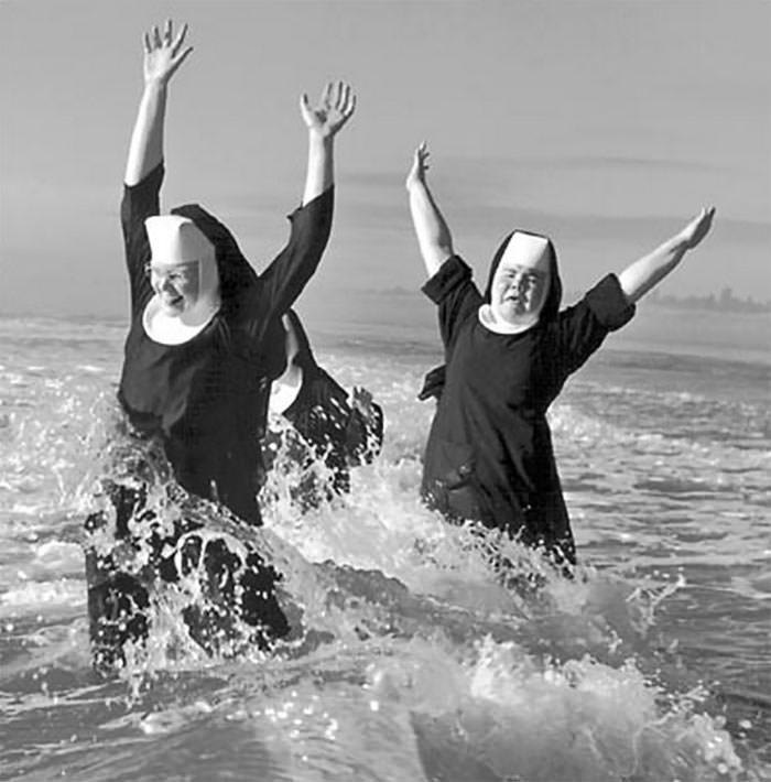 Nuns from the order of st. benedict make a splash in the pacific ocean while vacationing at grayland, 1960