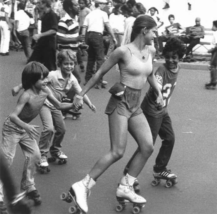 Roller girl skating with kids, 1970s