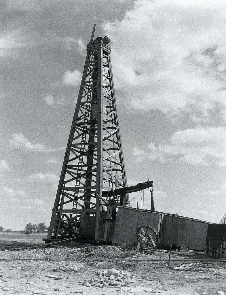 Oil well with wooden derrick, near Houston, Texas.