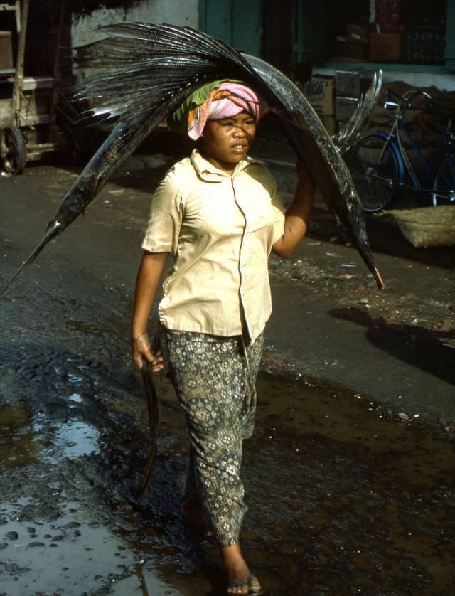 Balinese woman taking a swordfish to market, 1970s
