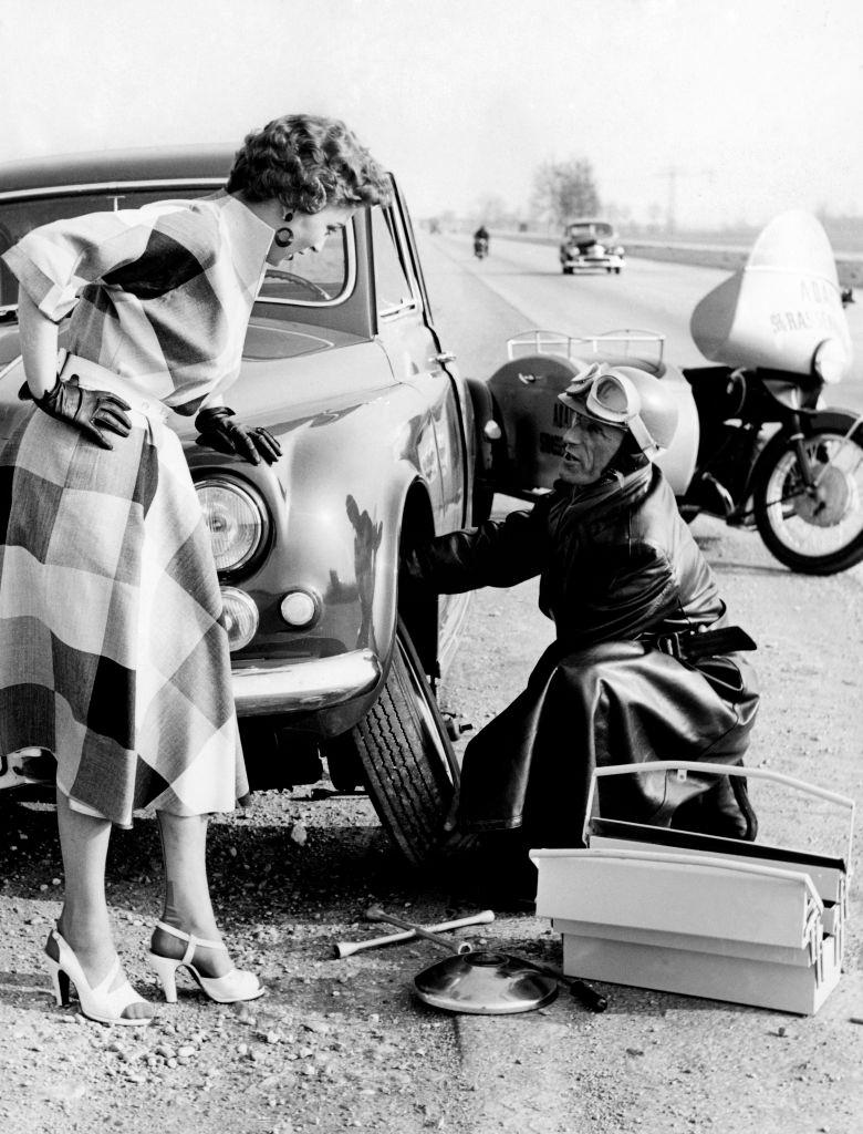 Woman with car trouble, 1960.