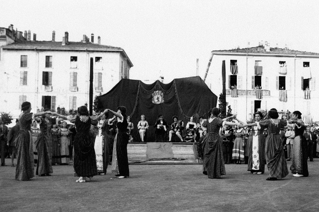 Inhabitants wearing costumes and dancing a portuguese dance during a pageant, Bettola, 1960s
