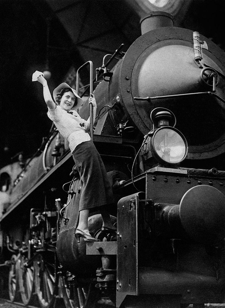 Young woman greeting from a locomotive waving her handkerchief, 1960s.