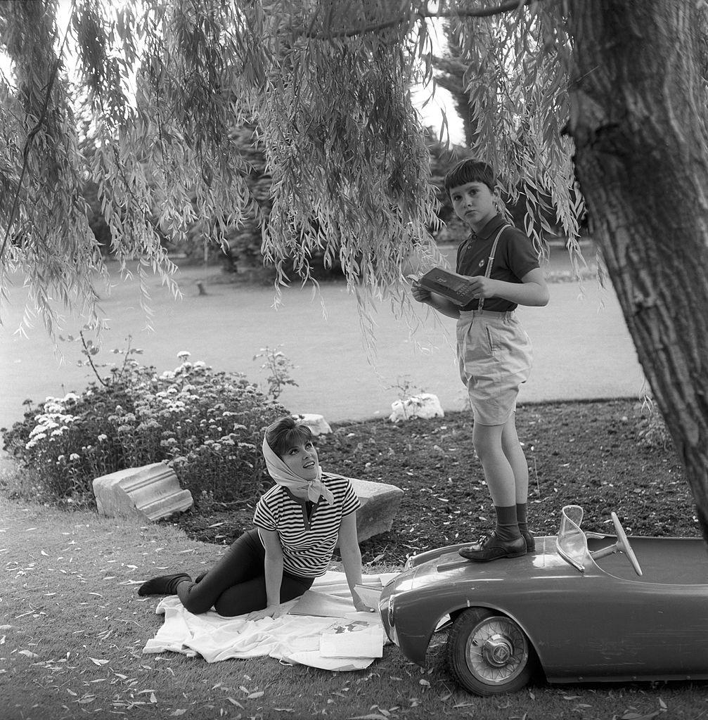 Gina Lollobrigida looking at her son Andrea Milko Skofic, 1960s.