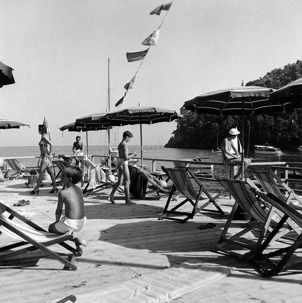 Bathers relaxing at the exclusive lido Paraggi on the riviera of Liguria, 1960s.