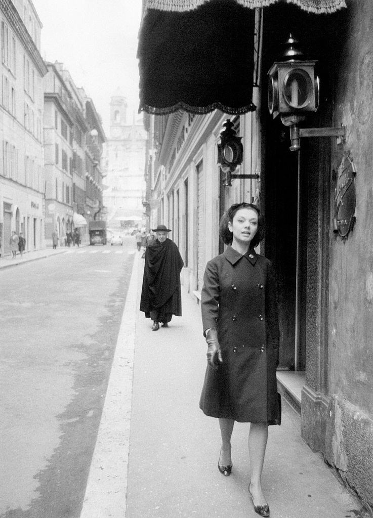 A young woman walking in via Condotti, 1960s.