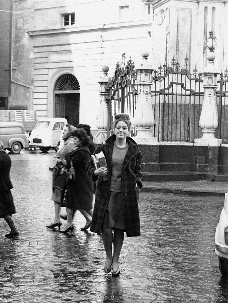A young student walking toward the entrance of the Liceo classico Antonio Genovesi. Naples, 1960s