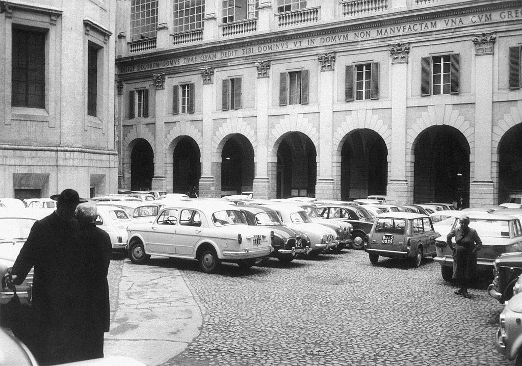 Cars parked in the courtyard of Archbishop's palace in Bologna, 1960s.