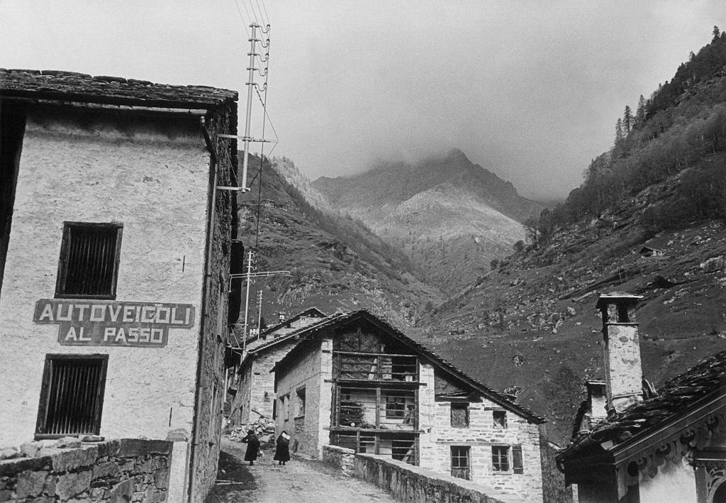 Two women walking in a street of the ancient village of Carcoforo, 1960s.