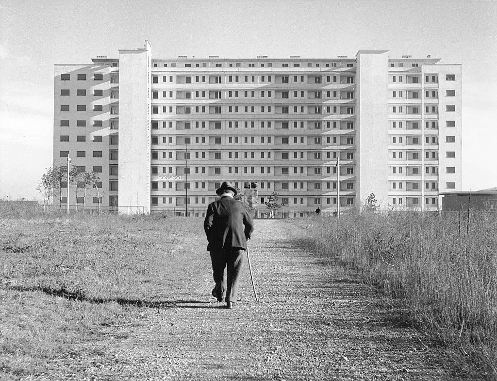 A man walking towards a building in QT8 quarter in Milan, 1960s.