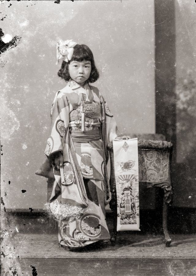 A young Japanese girl in kimono with traditional Shichi-Go-San candy (Chitose Ame)