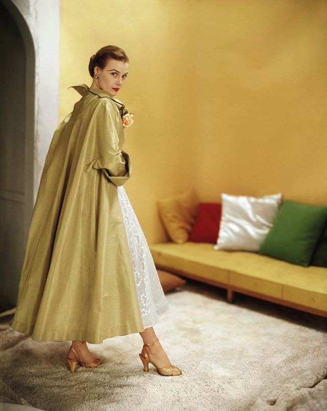 Lillian Marcuson in gold silk shantung evening coat over white organdy dress by Ceil Chapman, Vogue, February 1, 1951