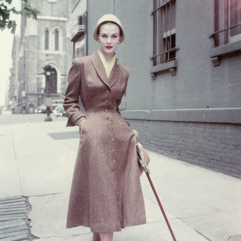Lillian Marcuson wears a brown coat dress in wool tweed by Vera Maxwell, September 1952