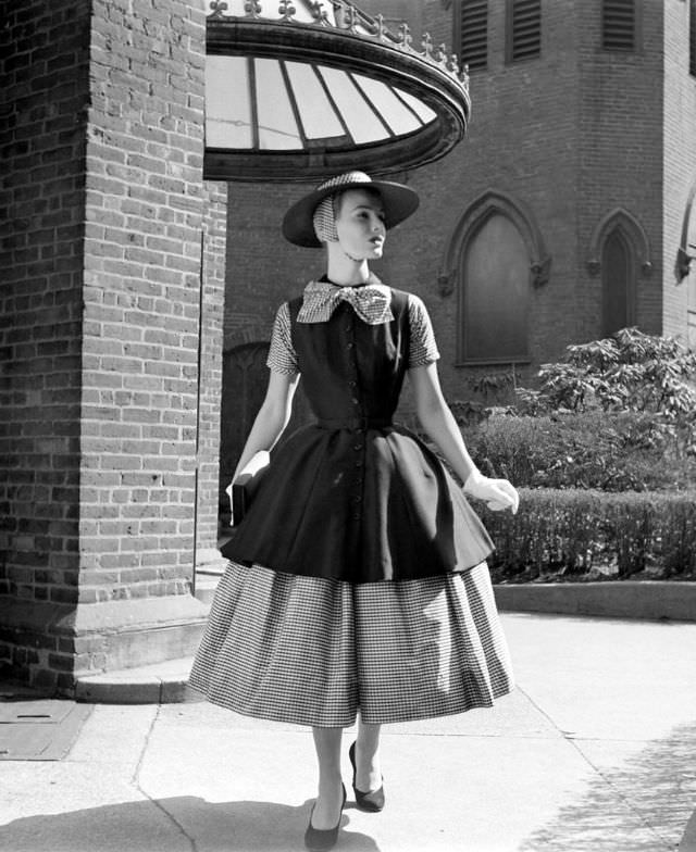 Lillian Marcuson is wearing a two-part dress suitable for town by Traina-Norell with a two-part hat by Emme, 1955