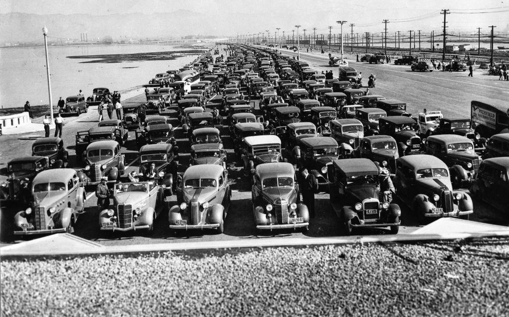 Cars line up at the toll plaza as far as the eye can see to be the first to cross the new bridge, Oakland, 1936.