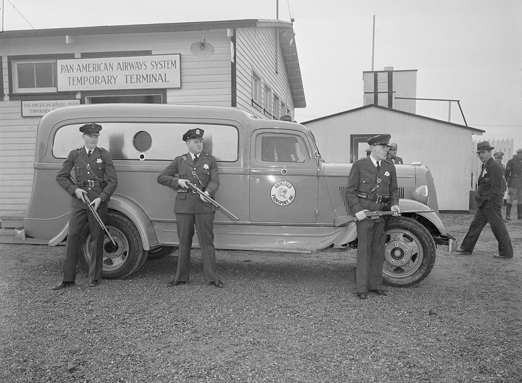 Police guarding trucks containing Panay bombing films at Oakland, 1937.