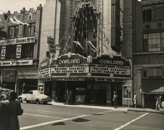 Fox Oakland Theater on Telegraph Avenue in Oakland, California showing banners, 1940s