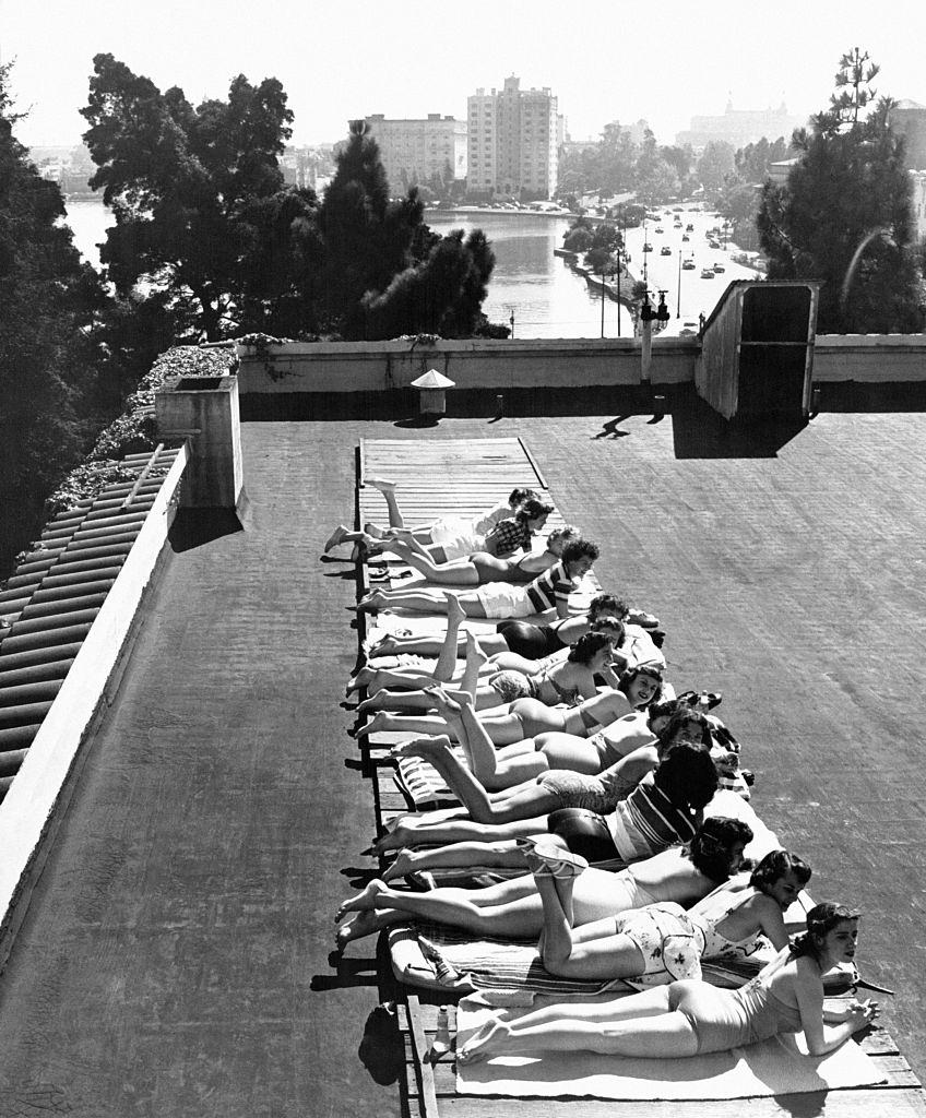 Young women sunbathing on the roof of the YWCA (Young Woman Christian Association) 'Blue Triangle Club' in Oakland, 1940s.