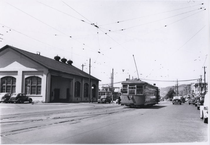 A street car rolls past the East Bay Street Railways Ltd. car, 1940s