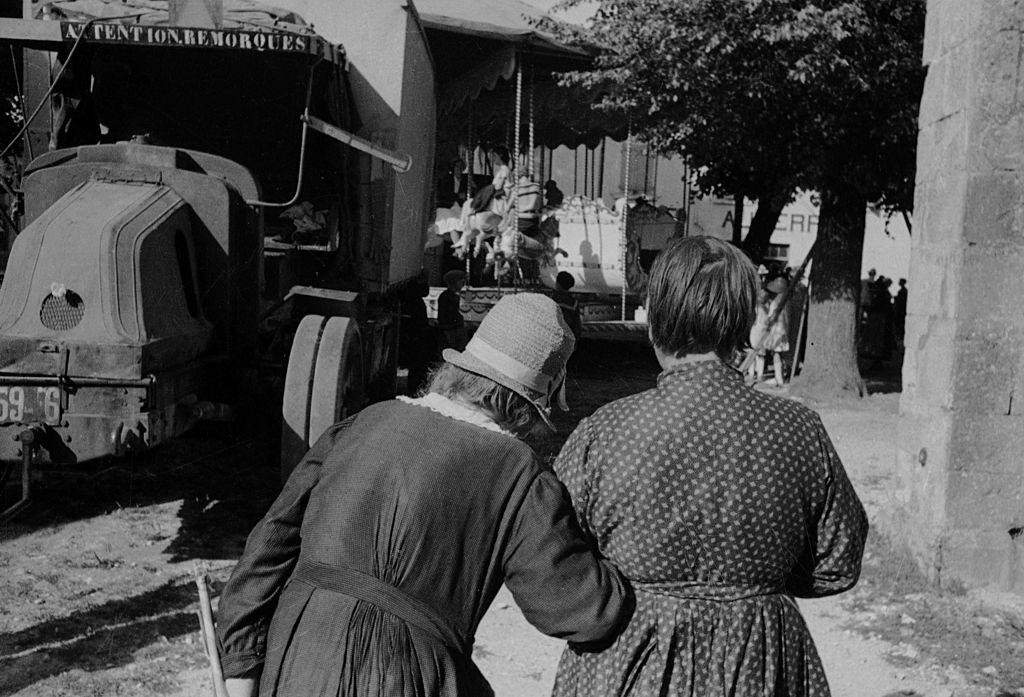 Women going to a fun fair. France, 1935.