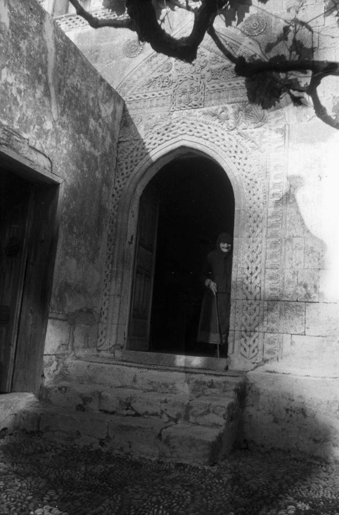 An old woman in the front door to her home in Rhodes, Greece, 1950s.