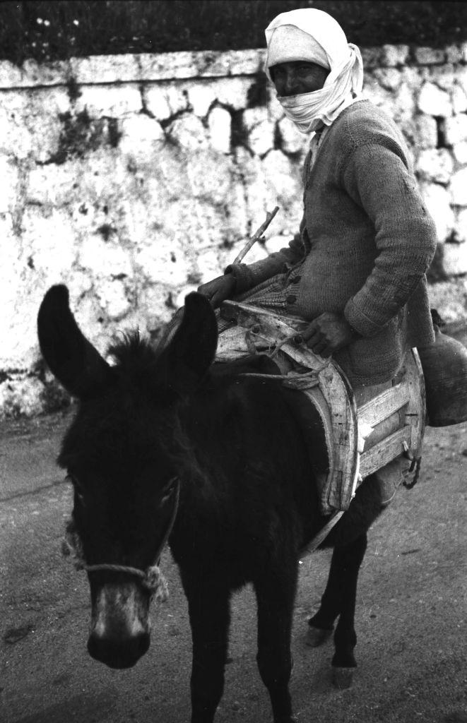 A woman on her donkey, Rhodes, Greece, 1950s.