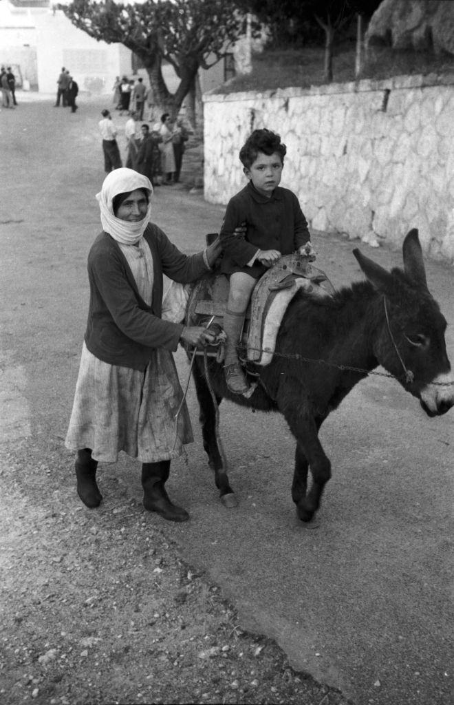 Mother and son out and about with their donkey in Rhodes, Greece, 1950s.