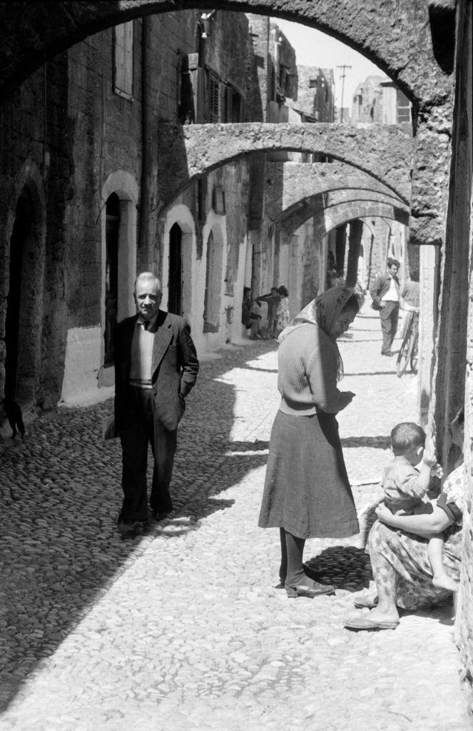 People in a small alley on Rhodes, Greece, 1950s.