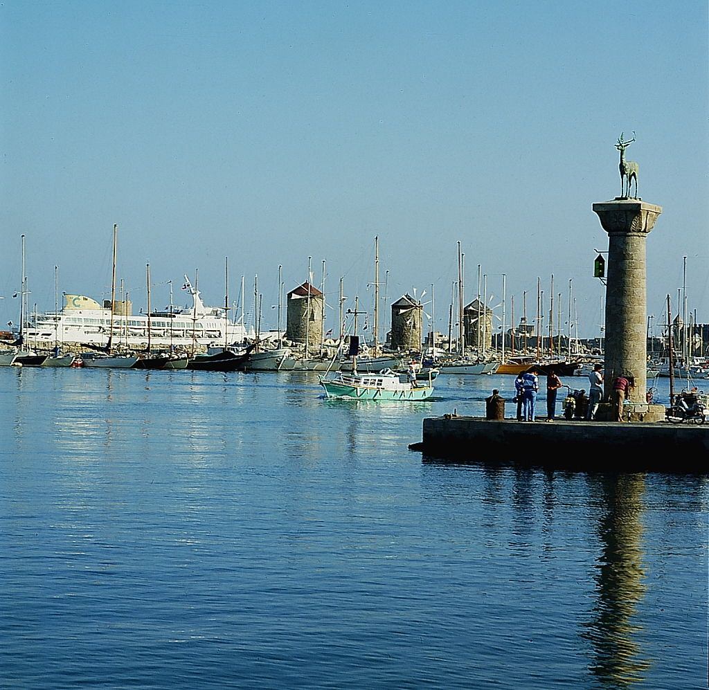View of the harbor entrance and the windmills of Rhodes, 1970s.