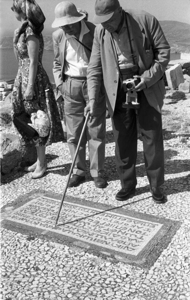 Tourists try to brush up their knowledge of the Greek language at the temple ruins of Ialyssos in Rhodes, Greece, 1950s.