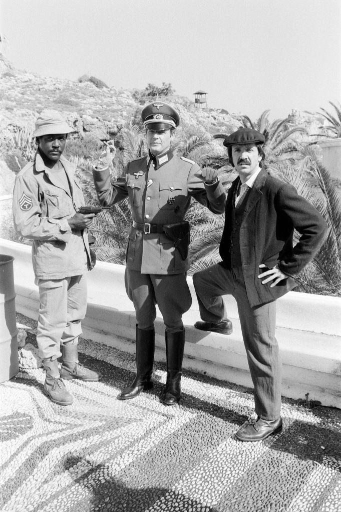 Richard Roundtree, Roger Moore and Sonny Bono on the set of 'Escape to Athena' in Rhodes, Greece, 8th March 1978.