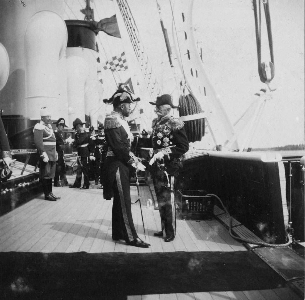 Tsar Nicholas II (left) greeting an unidentified man aboard the Standart.
