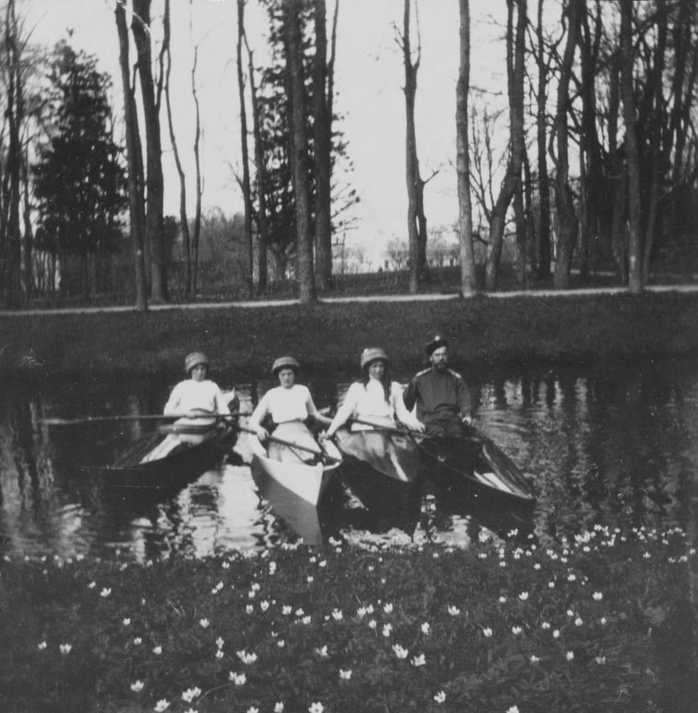 Nicholas II and three of the grand duchesses floating in one of the canals of Tsarskoe Selo, near St. Petersburg.