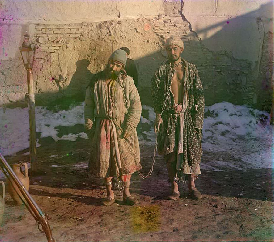 Two prisoners in shackles, ca. 1910s