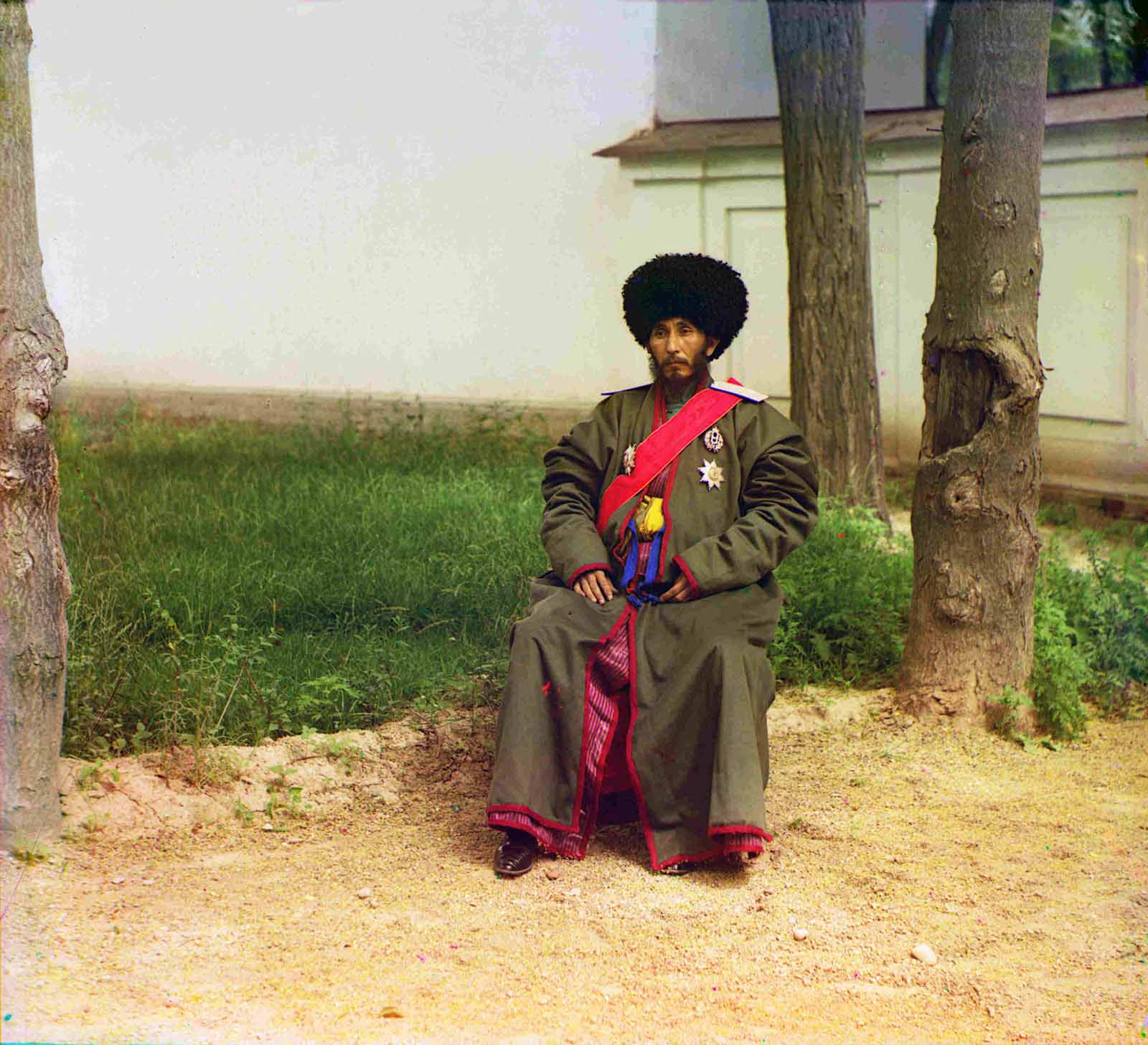 Isfandiyar Jurji Bahadur, Khan of the Russian protectorate of Khorezm (Khiva, now a part of modern Uzbekistan), full-length portrait, seated outdoors, 1910.