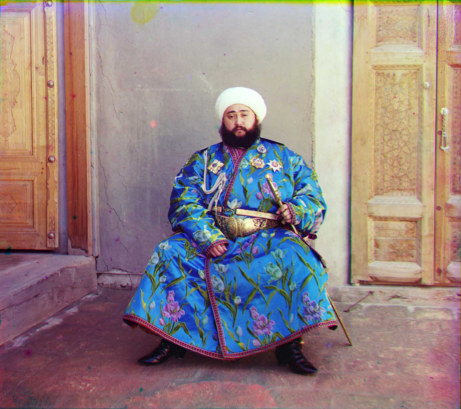 Emir Seyyid Mir Mohammed Alim Khan, the Emir of Bukhara, seated holding a sword in Bukhara, (present-day Uzbekistan), 1910.