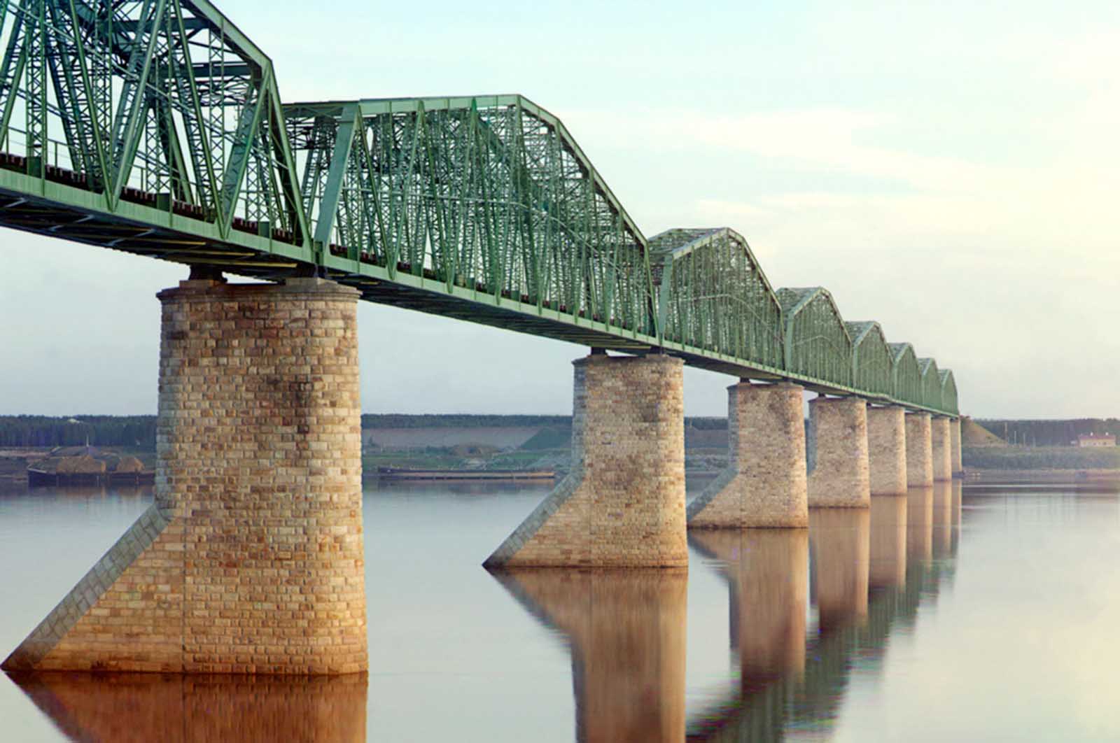 A metal truss bridge on stone piers, part of the Trans-Siberian Railway, crossing the Kama River near Perm, Ural Mountains Region, 1910.