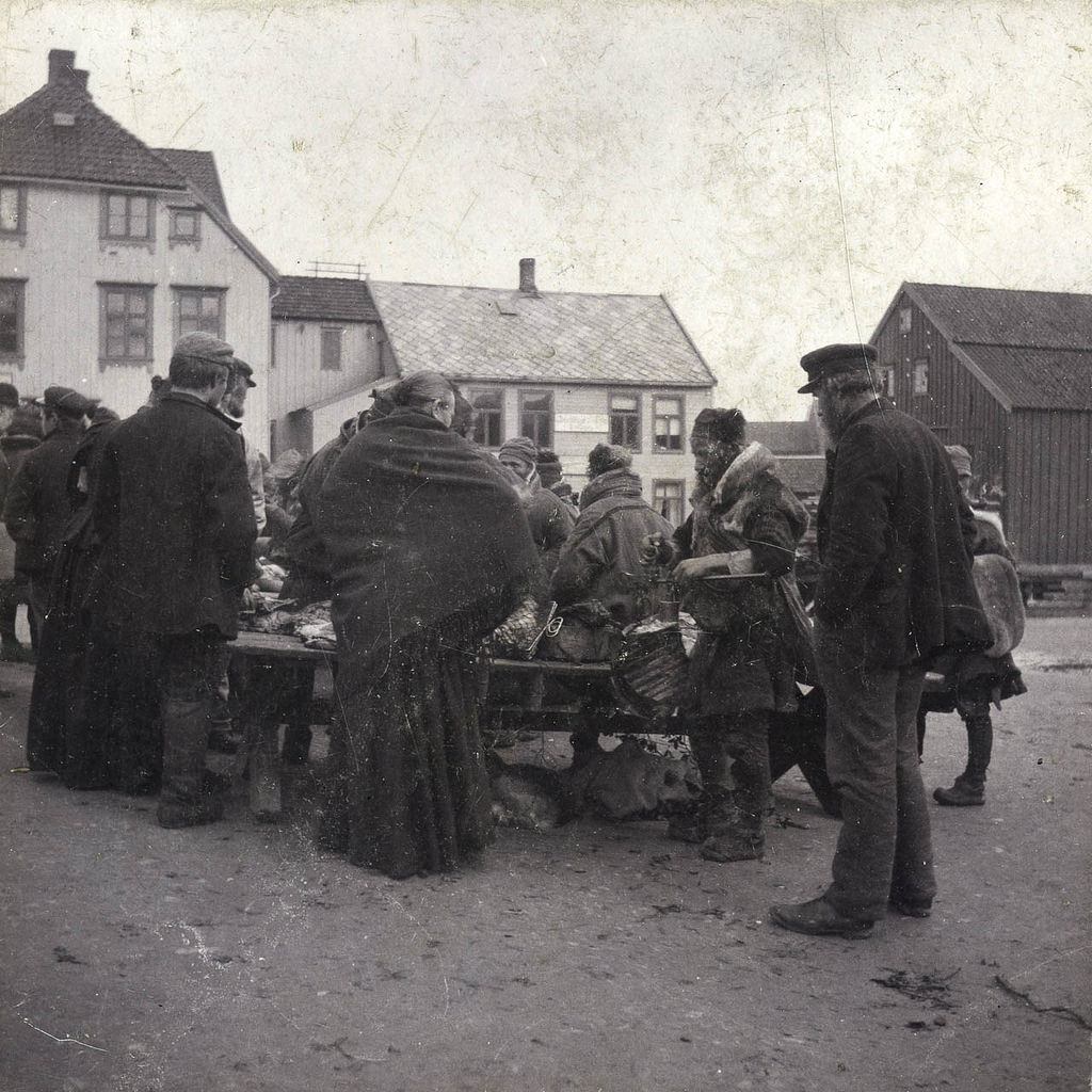 Sami men at a market in Tromso Norway around 1900.