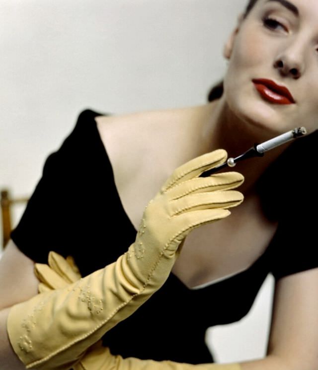 Model is wearing yellow doeskin gloves and cigarette holder by Alfred Orlik, 1946